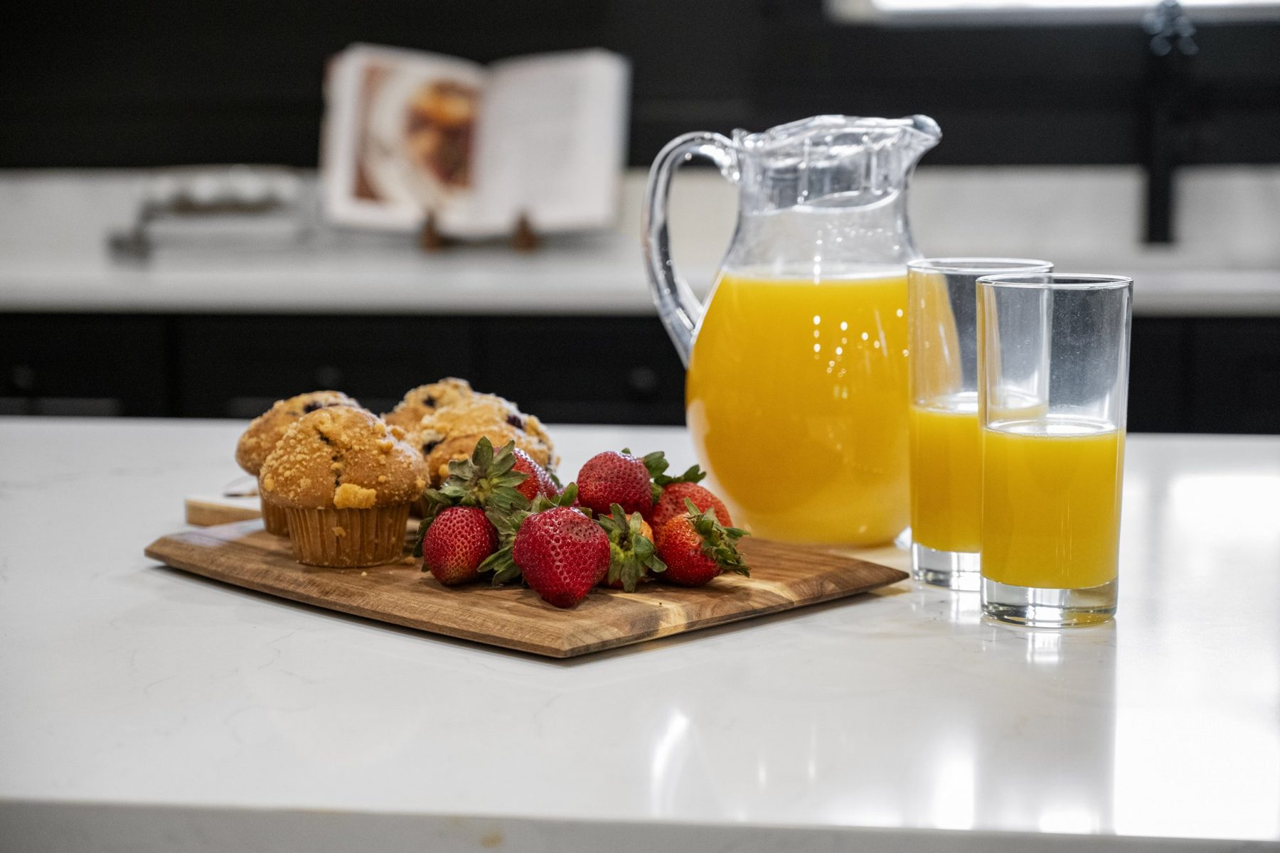 Welcome breakfast of muffins, strawberries and orange juice on the island