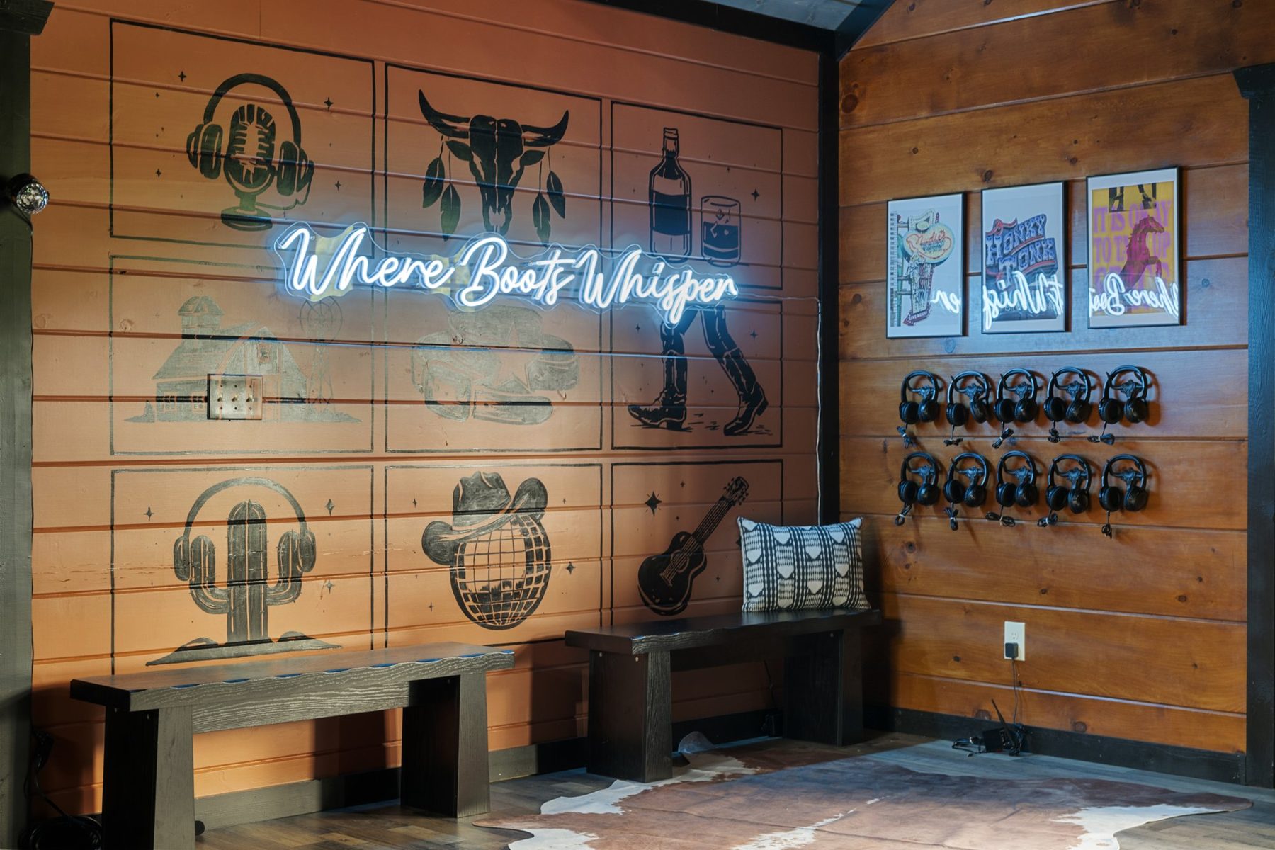 Speakeasy feature wall with a Where Boots Whisper neon sign and western stencils