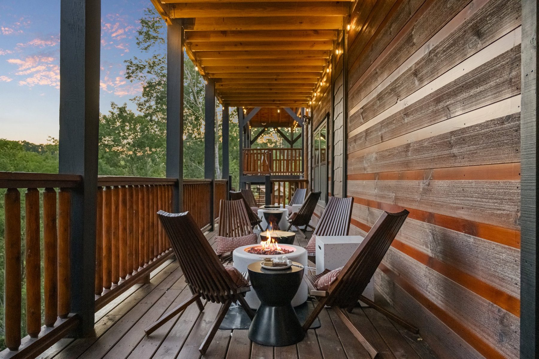 Covered balcony with sling chairs and a rough-sawn timber wall at golden hour