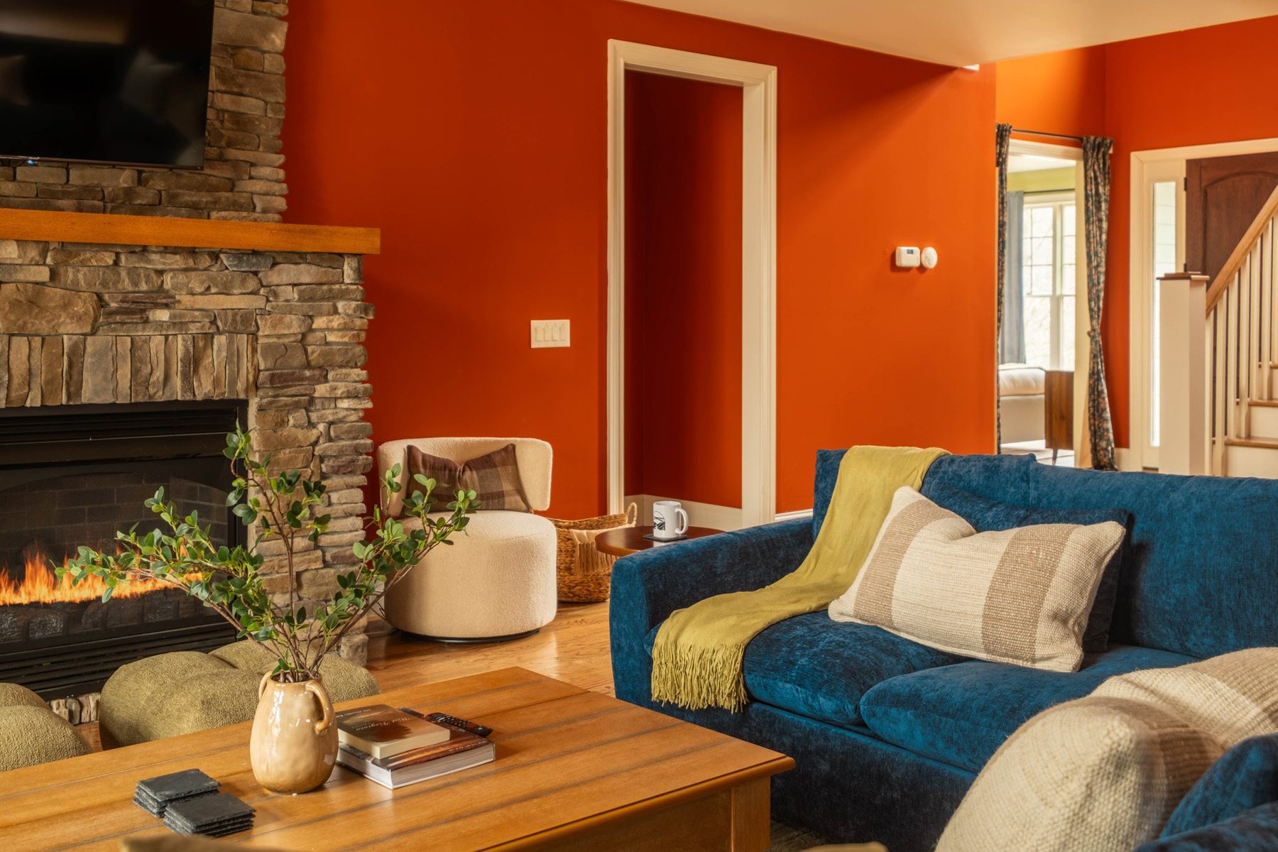 Living room seating with a chartreuse throw, oak coffee table and fireside lounge chairs