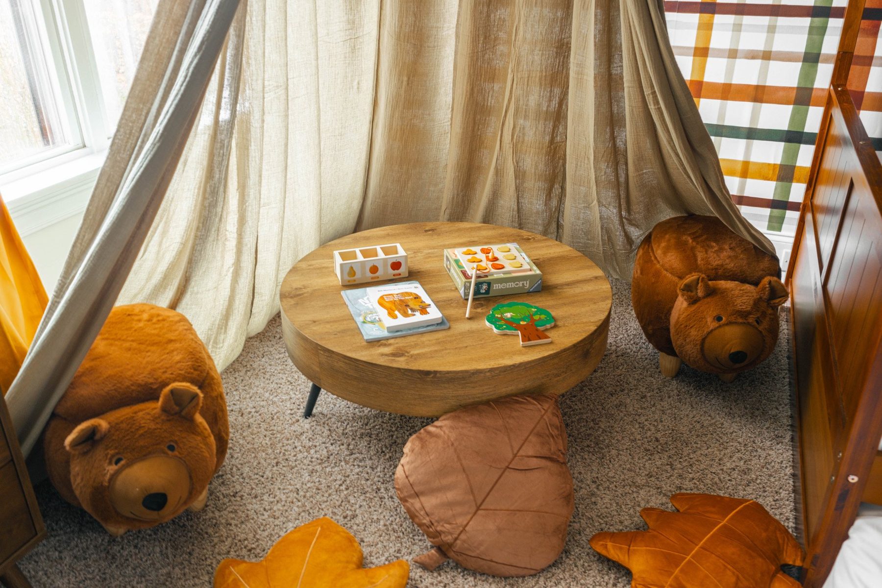 Canopy reading den with a round table, bear stools and leaf cushions