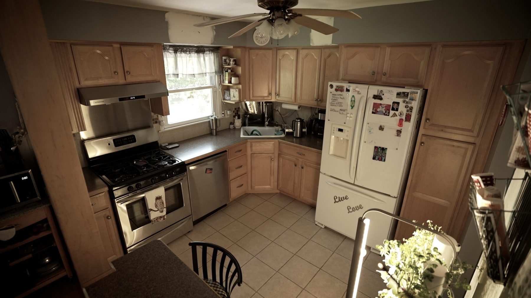Before: the closed-in kitchen with maple cabinets and a cramped layout