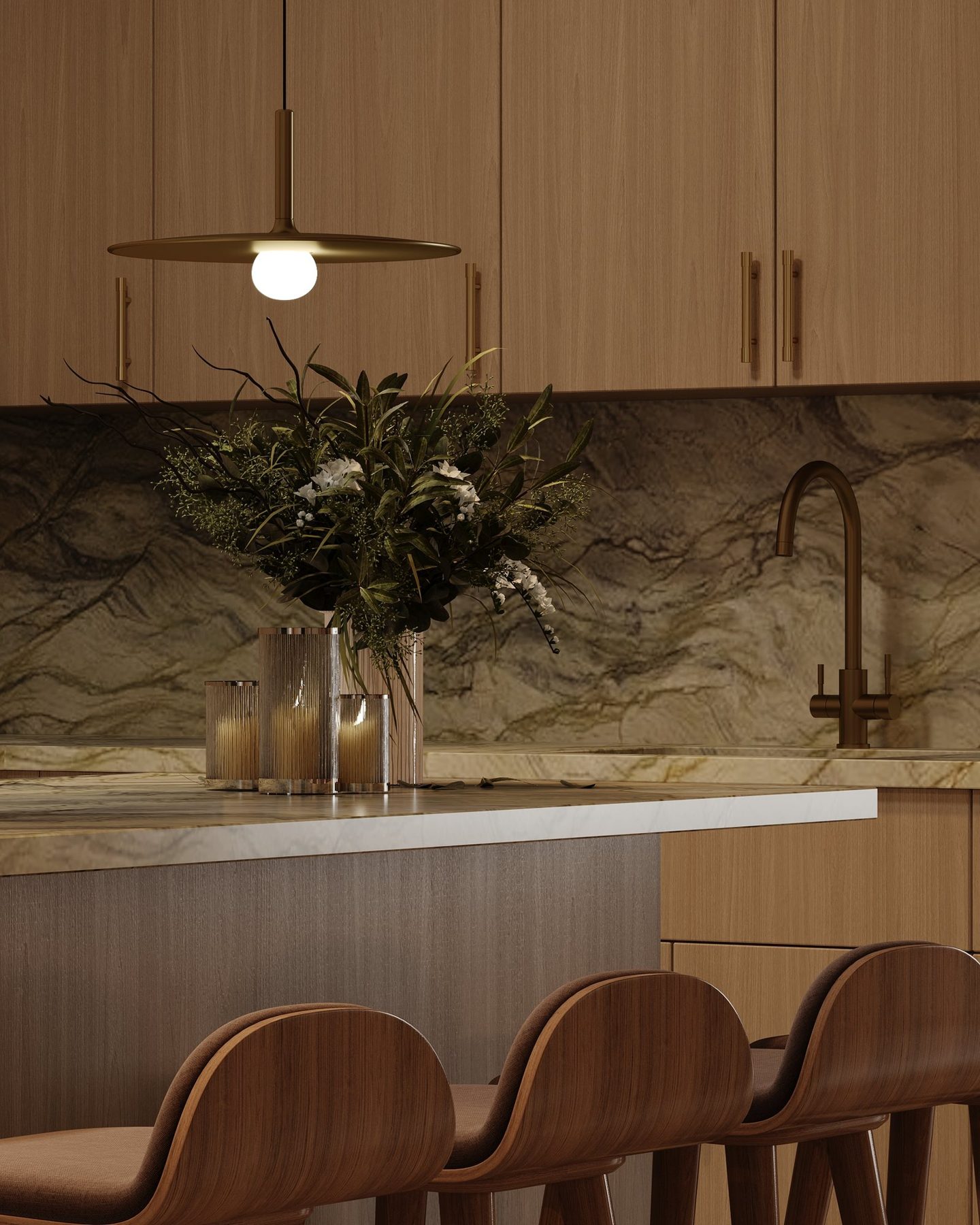Detail of the island: Verde green stone worktop, fluted glass candle holders and greenery under a brass pendant