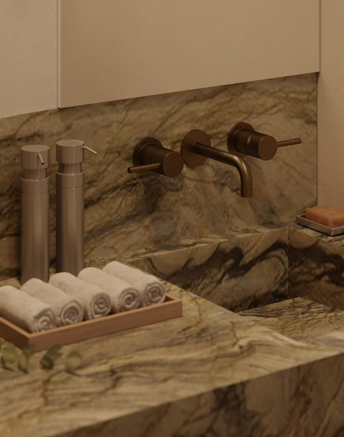 Powder room detail: bronze wall-mounted tap over the Verde green stone basin, with rolled towels